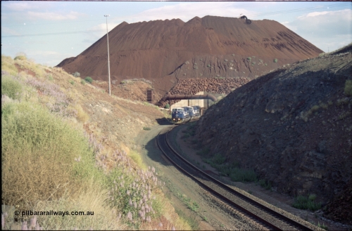 221-27
Yandi One mine loadout balloon loop, a pair of General Electric AC6000 units lead a train being loaded around the balloon, overview of the stockpile with stacker fill the hole from loading.
Keywords: GE;AC6000CW;