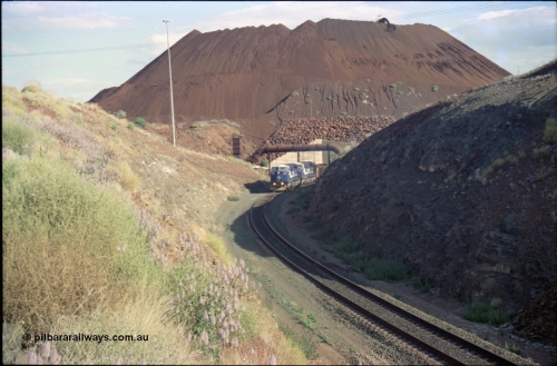 221-28
Yandi One mine loadout balloon loop, a pair of General Electric AC6000 units lead a train being loaded around the balloon, overview of the stockpile with stacker fill the hole from loading.
Keywords: GE;AC6000;51062-9;