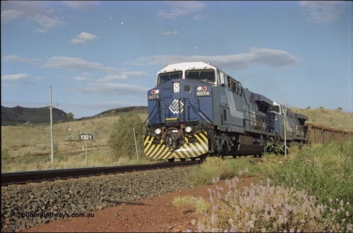 221-31
Yandi One mine loadout balloon loop, near new General Electric AC6000 unit 6074 serial 51066 leads sister unit 6071 serial 51063 at the Y312.1 km crossing while controlling a train being loaded.
Keywords: 6074;GE;AC6000CW;51066;