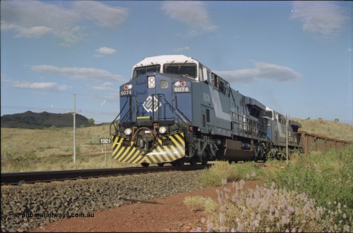 221-32
Yandi One mine loadout balloon loop, near new General Electric AC6000 unit 6074 serial 51066 leads sister unit 6071 serial 51063 at the Y312.1 km crossing while controlling a train being loaded.
Keywords: 6074;GE;AC6000CW;51066;