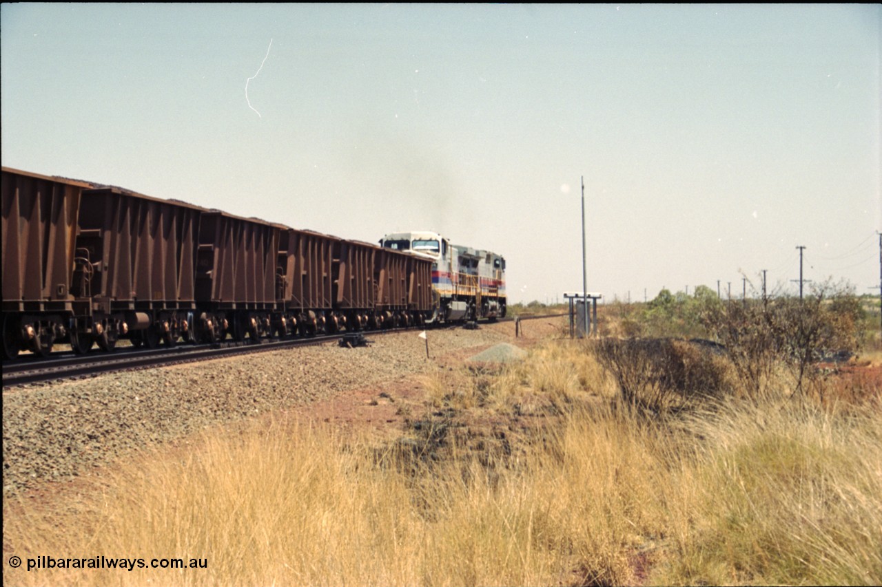 222-35
Somewhere on the original single line section between Gull and Rosella a pair of Hamersley Iron General Electric Dash 9-44CW's built by GE at Erie power a loaded train towards Dampier from the passing track back onto the mainline following a crew change.
