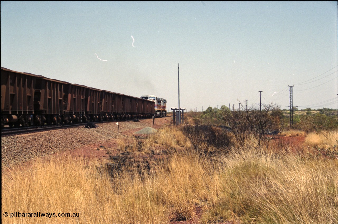 222-36
Somewhere on the original single line section between Gull and Rosella a pair of Hamersley Iron General Electric Dash 9-44CW's built by GE at Erie power a loaded train towards Dampier from the passing track back onto the mainline following a crew change.
