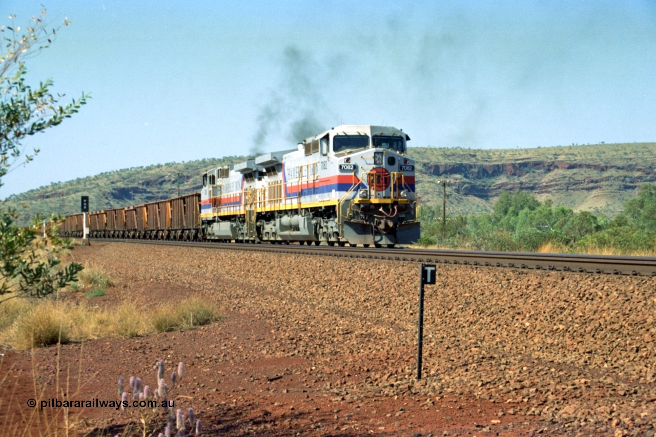 223-23
Possum Siding, Hamersley Iron loco 7082 a General Electric built Dash 9-44CW serial 47761 leads sister unit 7080 with an empty train as they power up to pull forward inside the loop to effect a crew change. 21st October 2000.
Keywords: 7082;47761;GE;Dash-9-44CW;