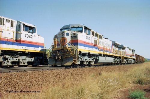 223-25
Possum Siding, Hamersley Iron locos built by General Electric model Dash 9-44CW units 7072 serial 47751 with 210 waggons loaded ex Marandoo changes crew with sister loco 7082 serial 47761 on an empty at 1500 hrs 21st October 2000.
Keywords: 7072;GE;Dash-9-44CW;47751;