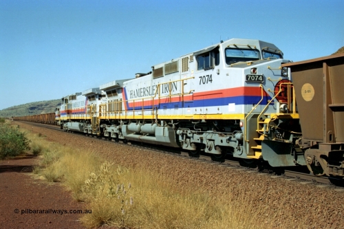 223-28
Possum Siding, trailing view of Hamersley Iron General Electric built Dash 9-44CW units 7072 in the lead and 7074 serial 47753 with a loaded train ex Marandoo having just completed a crew change with an empty train. 21st October 2000.
Keywords: 7074;GE;Dash-9-44CW;47753;