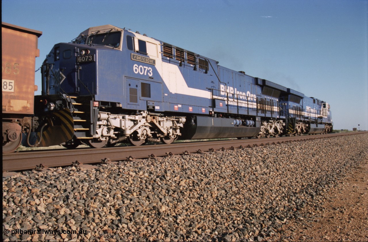 224-11
Bing siding, 6073 'Fortescue' serial 51065 a General Electric AC6000 built by GE at Erie awaits the road to depart south, shows new nameplate, steerable bogie and taper in cab side, second unit behind sister loco 6076. [url=https://goo.gl/maps/KQrczNpVhAH2]GeoData[/url].
Keywords: 6073;51065;GE;AC6000;