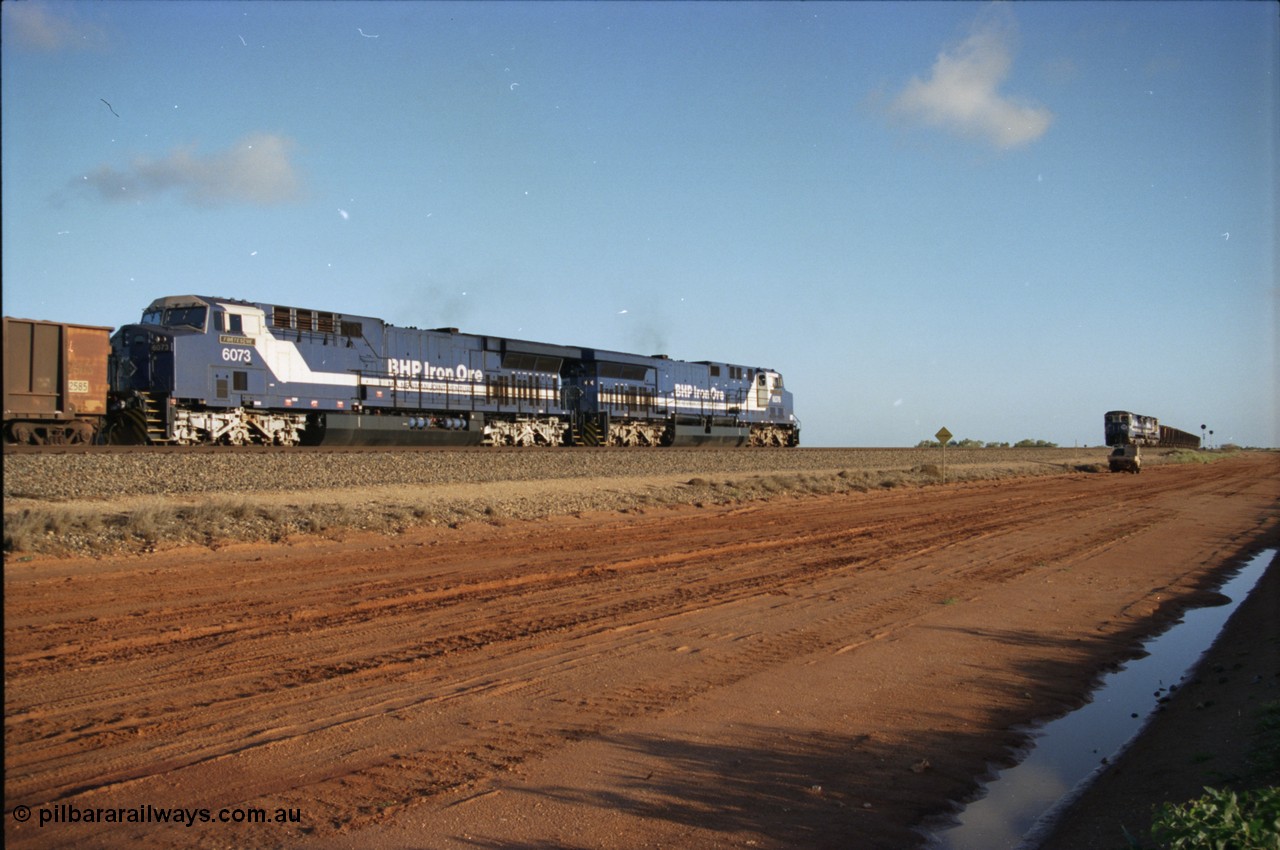 224-21
Bing siding, the afternoon empty to Yandi was a staple of the AC6000 units when delivered, operating the train as a pair, 112 waggons, AC6000 and 112 waggons. 6076 'Mt Goldsworthy' serial 51068 a General Electric AC6000 built by GE at Erie awaits the road to depart south with sister unit 6073 as a loaded behind two CM40-8M units rolls through on the mainline. [url=https://goo.gl/maps/KQrczNpVhAH2]GeoData[/url].
Keywords: 6073;GE;AC6000;51065;