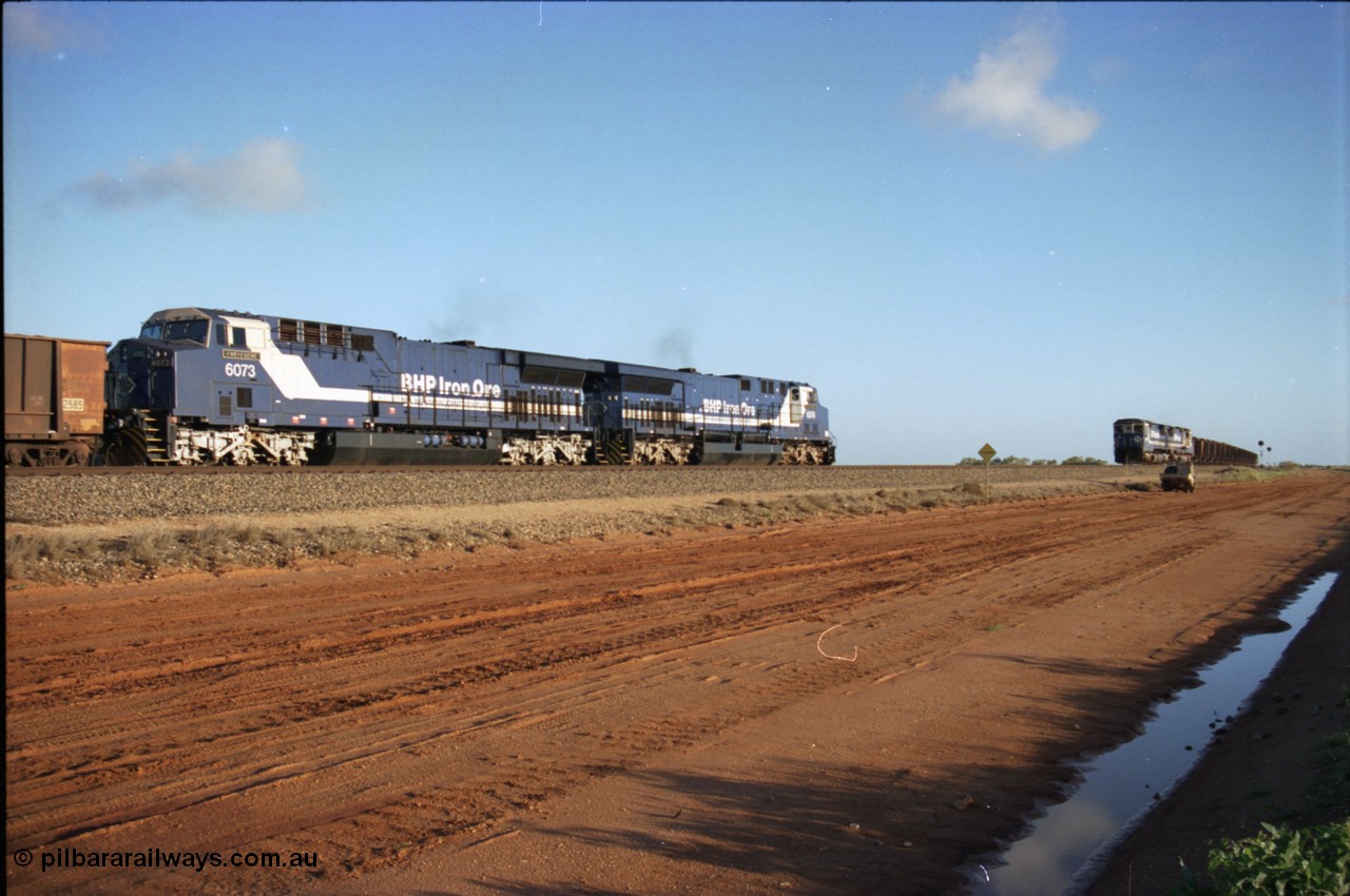 224-22
Bing siding, the afternoon empty to Yandi was a staple of the AC6000 units when delivered, operating the train as a pair, 112 waggons, AC6000 and 112 waggons. 6076 'Mt Goldsworthy' serial 51068 a General Electric AC6000 built by GE at Erie awaits the road to depart south with sister unit 6073 as a loaded behind two CM40-8M units rolls through on the mainline. [url=https://goo.gl/maps/KQrczNpVhAH2]GeoData[/url].
Keywords: 6073;GE;AC6000;51065;