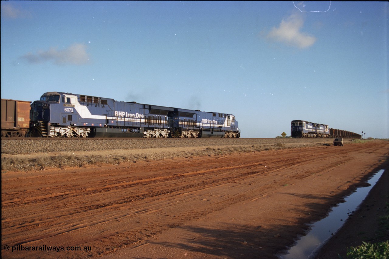 224-23
Bing siding, the afternoon empty to Yandi was a staple of the AC6000 units when delivered, operating the train as a pair, 112 waggons, AC6000 and 112 waggons. 6076 'Mt Goldsworthy' serial 51068 a General Electric AC6000 built by GE at Erie awaits the road to depart south with sister unit 6073 as a loaded behind two CM40-8M units rolls through on the mainline. [url=https://goo.gl/maps/KQrczNpVhAH2]GeoData[/url].
Keywords: 6073;GE;AC6000;51065;
