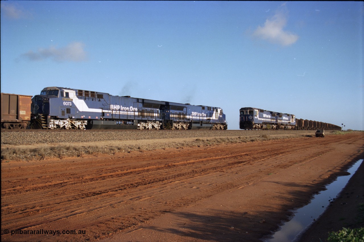 224-24
Bing siding, the afternoon empty to Yandi was a staple of the AC6000 units when delivered, operating the train as a pair, 112 waggons, AC6000 and 112 waggons. 6076 'Mt Goldsworthy' serial 51068 a General Electric AC6000 built by GE at Erie awaits the road to depart south with sister unit 6073 as a loaded behind two CM40-8M units rolls through on the mainline. [url=https://goo.gl/maps/KQrczNpVhAH2]GeoData[/url].
Keywords: 6073;GE;AC6000;51065;