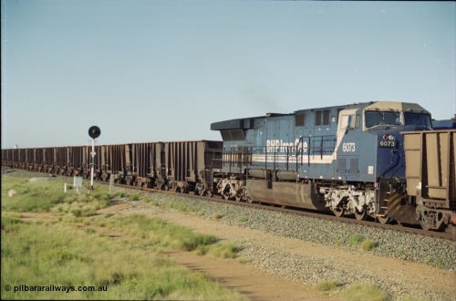 225-08
Bing siding, General Electric AC6000 model unit 6073 serial 51065 built at GE Erie is the mid-train remote for the afternoon empty Yandi mine train as it heads south. This was before the units were named. [url=https://goo.gl/maps/r3bVfZz8aJS2]GeoData[/url].
Keywords: 6073;GE;AC6000CW;51065;
