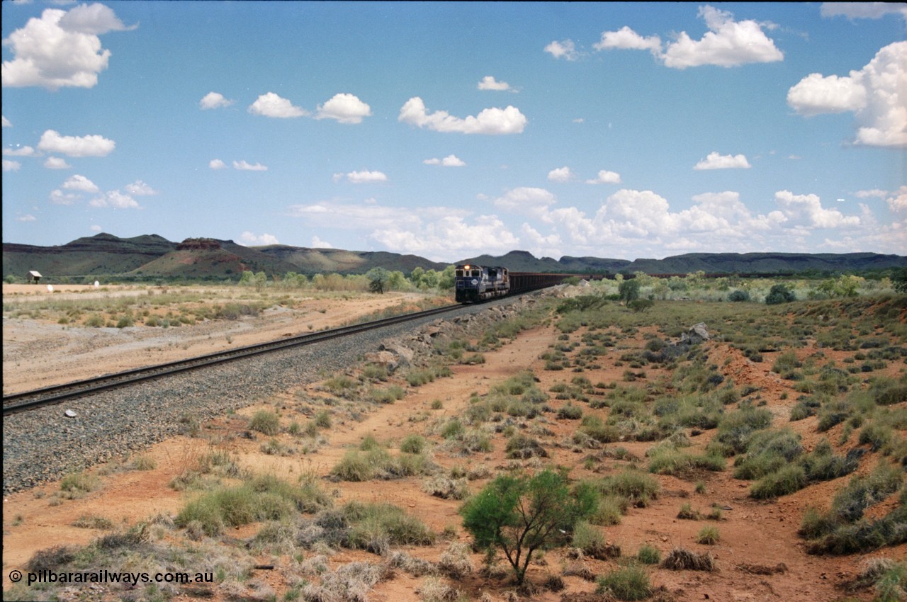 226-05
Redmont, at the 202 km, a loaded Yandi train descends the .76 percent grade with the standard of the time Double Dash 8 combination with 5653 and 5643 leading the charge. [url=https://goo.gl/maps/HYx9nXwpXfP2]GeoData[/url].
