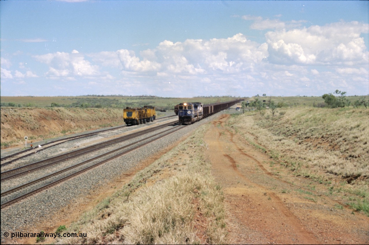 226-23
Shaw siding at the 219 km a loaded train with standard double CM40-8M power blasts along the mainline with the rear portion still on a .55 percent grade as it passes the Speno rail grinder in the back track. [url=https://goo.gl/maps/JLjSYskHScU2]GeoData[/url].
