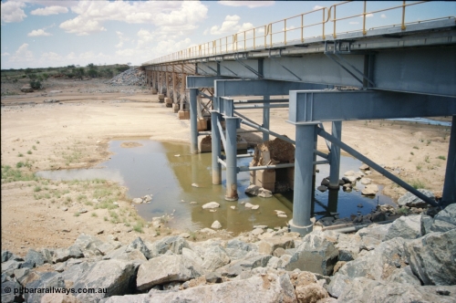 226-03
Yule River bridge showing new piles and deck to replace flood damaged piles after a cyclone that closed the line for two weeks in the late 1990s. [url=https://goo.gl/maps/G67Mat23u4P2]GeoData[/url].
