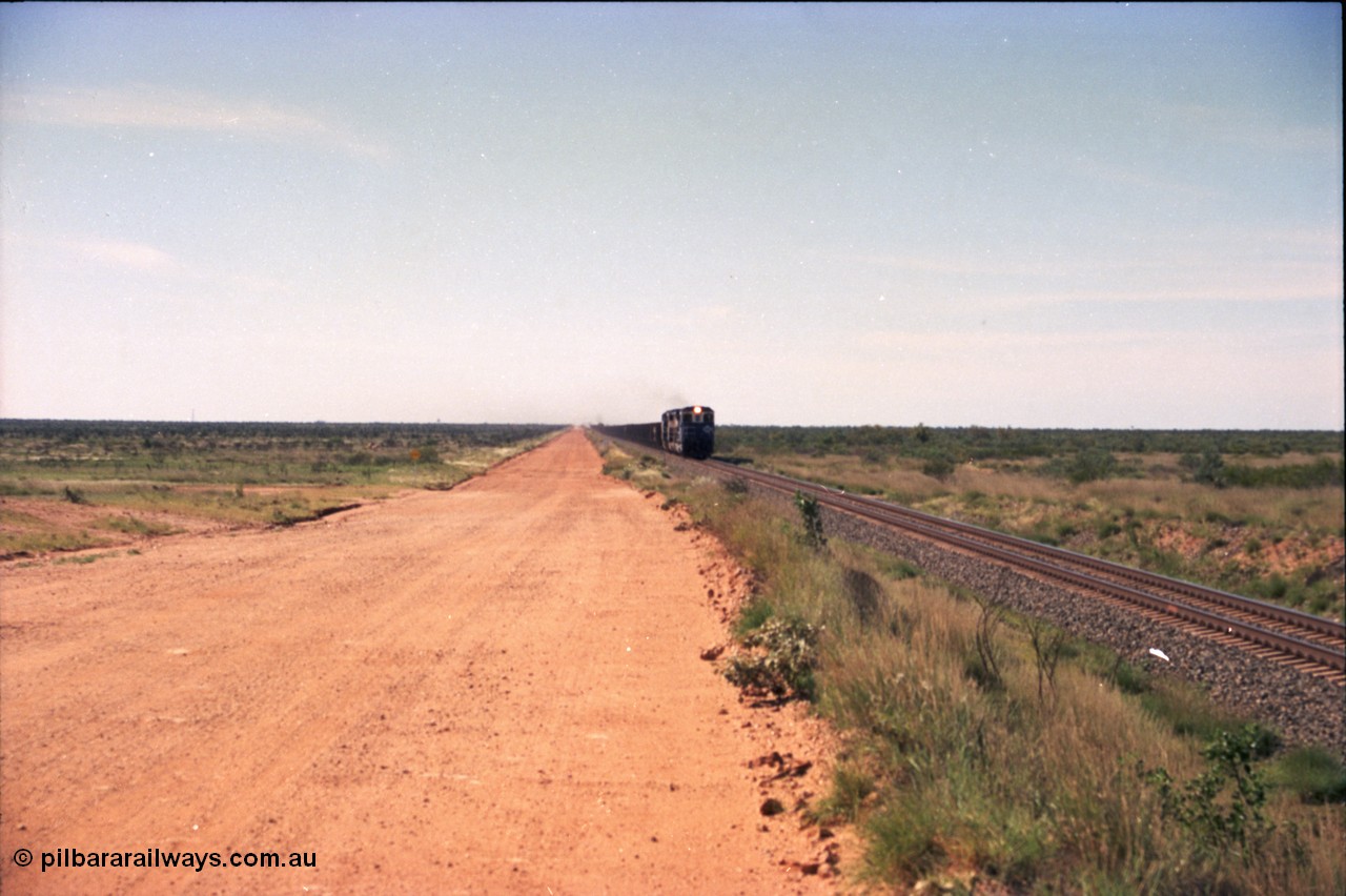 227-18
30 km area on the Newman mainline, east of the original Quarry 1, an empty train powers along the gentle .17% rising grade behind a pair of Goninan CM40-8M GE rebuild units and an General Electric AC6000. [url=https://goo.gl/maps/BY7Zz4F5t822]GeoData[/url].
