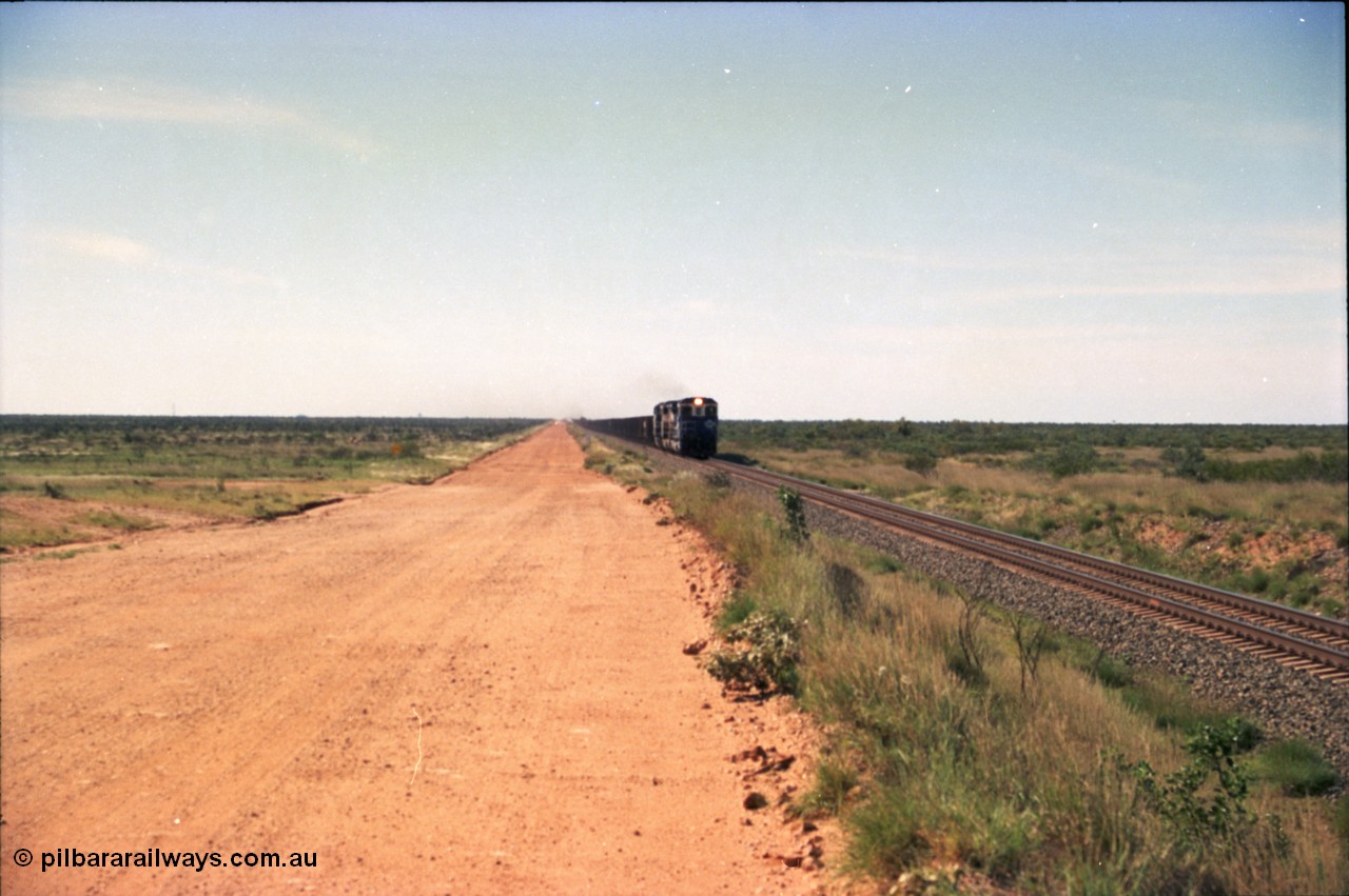 227-19
30 km area on the Newman mainline, east of the original Quarry 1, an empty train powers along the gentle .17% rising grade behind a pair of Goninan CM40-8M GE rebuild units and an General Electric AC6000. [url=https://goo.gl/maps/BY7Zz4F5t822]GeoData[/url].
