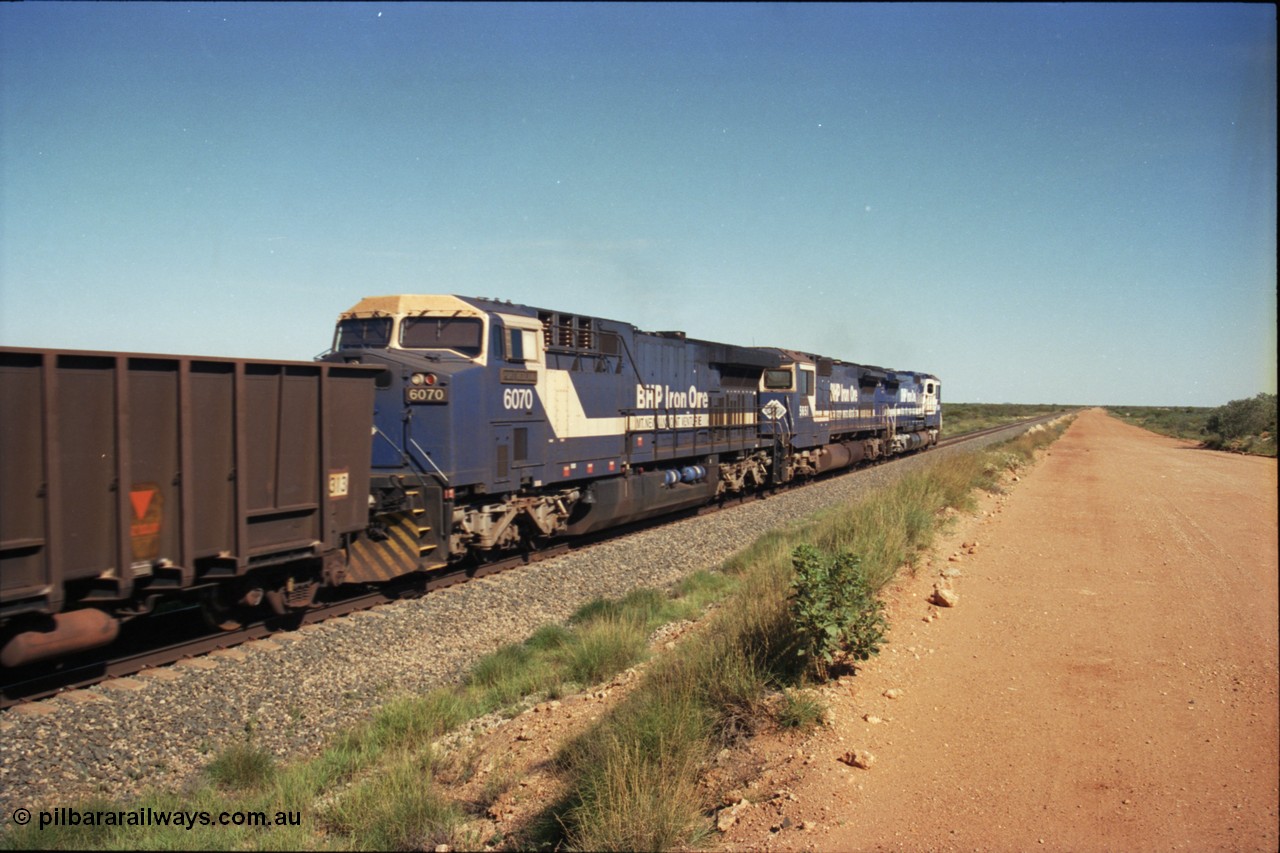 227-25
30 km area, third unit on an empty ore train is class leader 6070 'Port Hedland' serial 51062 a General Electric AC6000 built by GE Erie. [url=https://goo.gl/maps/BY7Zz4F5t822]GeoData[/url].
Keywords: 6070;GE;AC6000;51062;