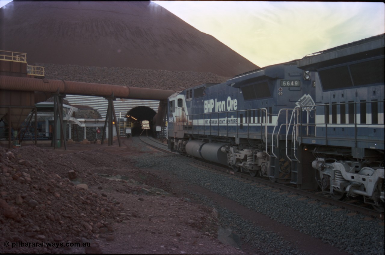 228-29
Yandi Two load-out tunnel, view of empty train about to enter for loading behind a standard pair of Goninan rebuilt GE CM40-8M model units 5649 'Pohang' serial 8412-07/93-140 and 5644 'Kangan' serial 8281-09/92-133. Geodata [url=https://goo.gl/maps/KbzBN9Bt4k52] -22.720824, 119.043410 [/url].
Keywords: 5649;Goninan;GE;CM40-8M;8412-07/93-140;rebuild;AE-Goodwin;ALCo;M636C;5473;G6047-5;