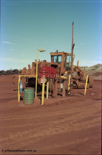 228-13
Yandi Two mobile machine fuel point. A Caterpillar 16G road motor grader is receiving attention.
Keywords: Caterpillar;16G;