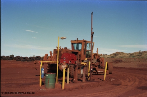 228-14
Yandi Two mobile machine fuel point. A Caterpillar 16G road motor grader is receiving attention.
Keywords: Caterpillar;16G;