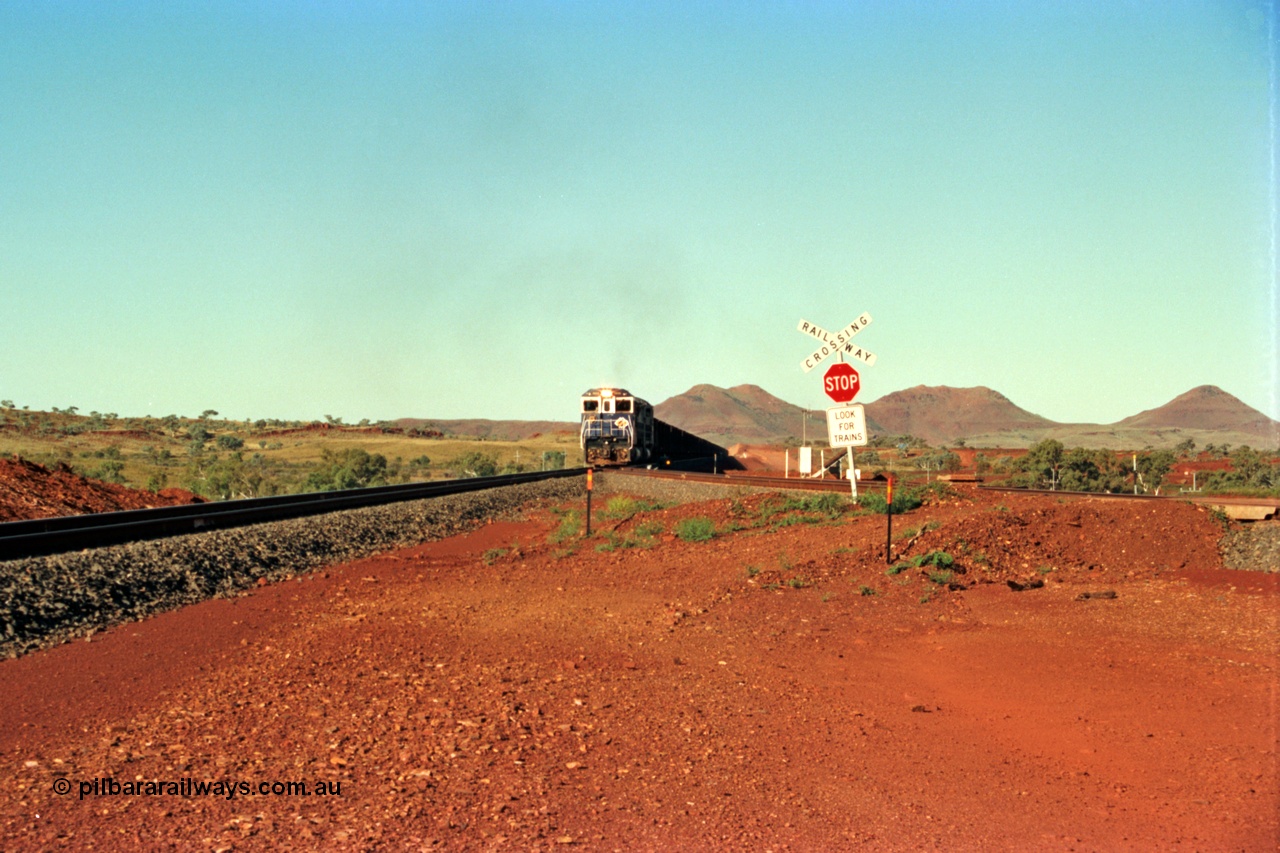 229-0A
Yandi Two balloon switch looking east with the Three Sisters forming the background. Empty BHP train heading for the balloon loop for loading, grade crossing is the YT 311.5 km. [url=https://goo.gl/maps/DcycDGojcBt]GeoData[/url].

