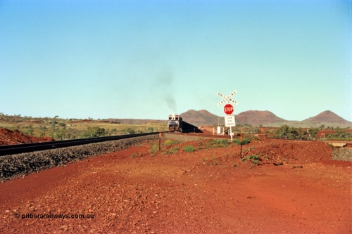 229-00
Yandi Two balloon switch looking east with the Three Sisters forming the background. Empty BHP train heading for the balloon loop for loading, grade crossing is the YT 311.5 km. [url=https://goo.gl/maps/DcycDGojcBt]GeoData[/url].
