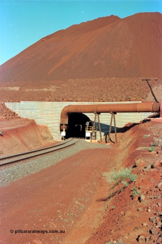229-14
Yandi Two loadout, looking through the tunnel and the CM40-8M profile of 5650 can be just made out, the massive pile of ore is gravity fed into the waggons via two sets of hydraulic chutes, Yandi Two features to loadout vaults for extra capacity, in later years it allowed two different products, fines and lumps to be stacked. [url=https://goo.gl/maps/jmtnauf76Zq]GeoData[/url].
