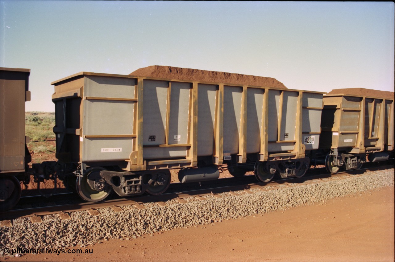 230-33
Yandi Two balloon loop, Goninan new build ore car 4239, build date of June 1997 from the original United Goninan WA order for 126 units with a tapered floor. Tare weight of 23.3 tonnes, loaded with Yandi Fines ore. Geodata [url=https://goo.gl/maps/h68ia1caJvL2] -22.718338, 119.039909 [/url].
Keywords: 4239;Comeng-WA;BHP-ore-waggon;