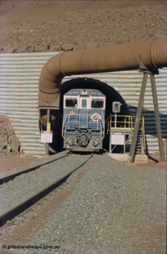 230-11
Yandi Two load-out tunnel exit side portal, Goninan rebuild GE CM40-8M model 5654 'Kashima' serial 8412-11/93-145 creeps out of the tunnel as its train is loaded at 1.2 km/h. The livery is the marigold version of the BHP Australia logo. Geodata [url=https://goo.gl/maps/h68ia1caJvL2] -22.718338, 119.039909 [/url].
Keywords: 5654;Goninan;GE;CM40-8M;8412-11/93-145;rebuild;Comeng-NSW;ALCo;M636C;5493;C6084-9;