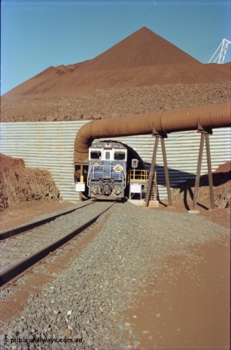 230-13
Yandi Two load-out tunnel exit side portal, Goninan rebuild GE CM40-8M model 5654 'Kashima' serial 8412-11/93-145 creeps out of the tunnel as its train is loaded at 1.2 km/h. The livery is the marigold version of the BHP Australia logo. Geodata [url=https://goo.gl/maps/h68ia1caJvL2] -22.718338, 119.039909 [/url].
Keywords: 5654;Goninan;GE;CM40-8M;8412-11/93-145;rebuild;Comeng-NSW;ALCo;M636C;5493;C6084-9;