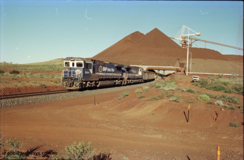230-25
Yandi Two balloon loop, view of the stockpile area and pedestal stacker, train being loaded at 1.2 km/h behind two Goninan GE CM40-8M rebuilds from different ALCo builders. 5654 'Kashima' serial 8412-11/93-145 is from Comeng ALCo M636 unit 5493 while 5637 'De Grey' serial 8181-01/92-123 is from an AE Goodwin ALCo C636 unit 5456. Geodata [url=https://goo.gl/maps/h68ia1caJvL2] -22.718338, 119.039909 [/url].
Keywords: 5654;Goninan;GE;CM40-8M;8412-11/93-145;rebuild;Comeng-NSW;ALCo;M636C;5493;C6084-9;