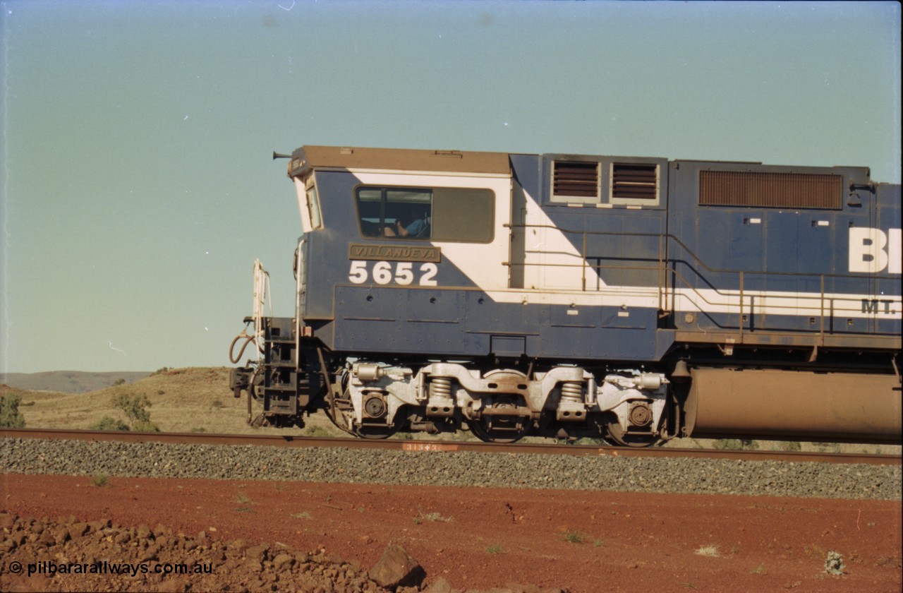 231-28
Yandi Two balloon loop, BHP Iron Ore 5652 'Villanueva' serial 8412-09 / 93-143 an Goninan WA rebuild CM40-8M GE unit loads a train at 1.2 km/h, note the missing logo from the hood and the round style fuel tanks tells us this units was rebuilt from an AE Goodwin built M636 ALCo. [url=https://goo.gl/maps/3vQHZqBXNa32]GeoData[/url].
Keywords: 5652;Goninan;GE;CM40-8M;8412-09/93-143;rebuild;AE-Goodwin;ALCo;M636C;5482;G6061-3;