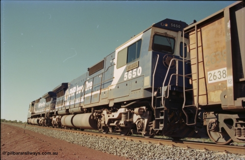 231-16
Yandi Two balloon loop, BHP Iron Ore 5650 'Yawata' serial 8412-09 / 93-141 an Goninan WA rebuild CM40-8M GE unit loads a train at 1.2 km/h as second unit, note the logos are the original teal and marigold and the round style fuel tanks tells us this units was rebuilt from an AE Goodwin built M636 ALCo. [url=https://goo.gl/maps/3vQHZqBXNa32]GeoData[/url].
Keywords: 5650;Goninan;GE;CM40-8M;8412-07/93-141;rebuild;AE-Goodwin;ALCo;M636C;5481;G6061-2;