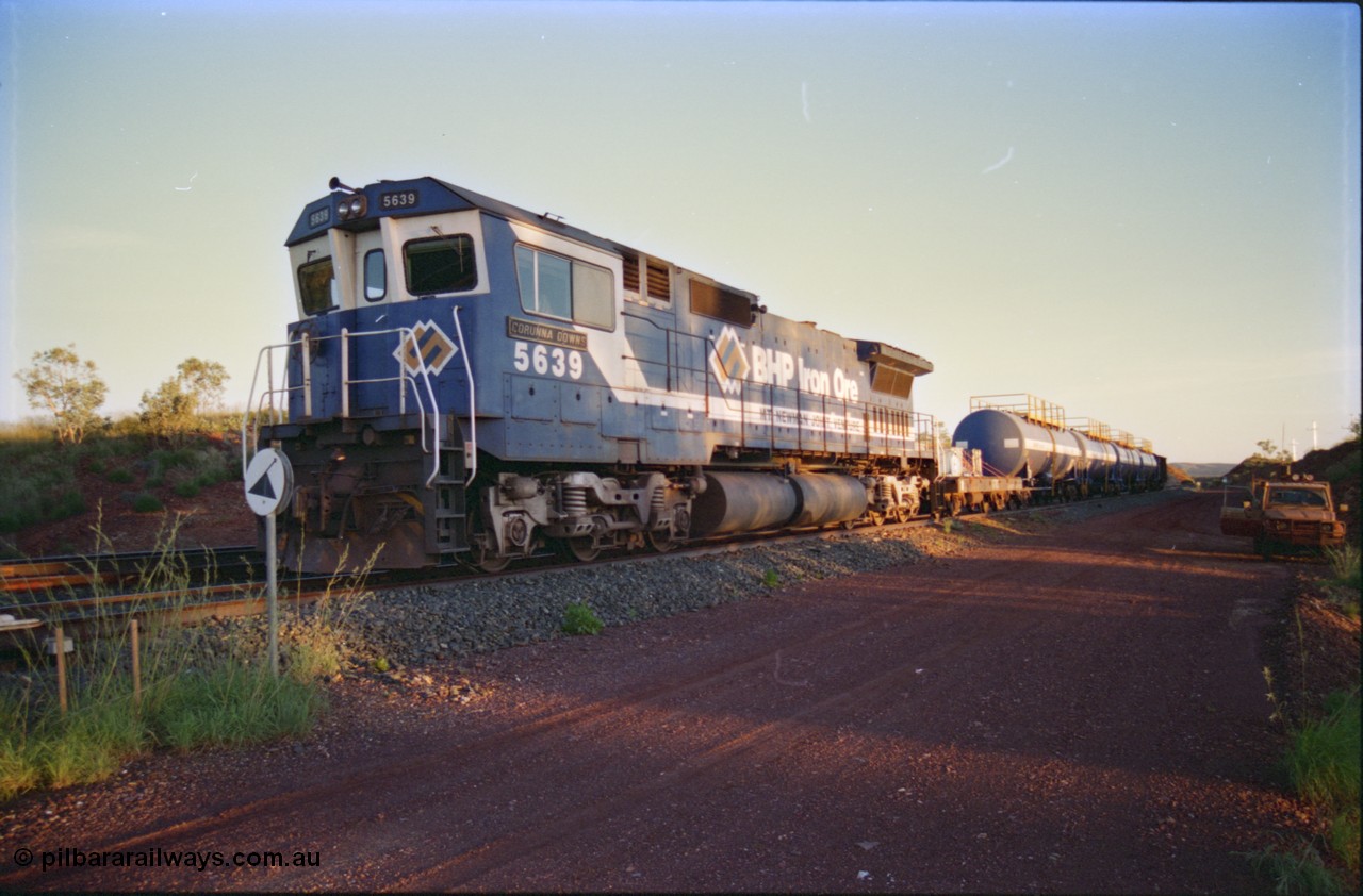 232-11
Yandi One backtrack, following a cyclone shutdown of the mainline and severe flooding around Yandi a 'mixed' freight train was operated to Yandi to deliver food, mail and diesel fuel to the mine and camp. Here BHP Iron Ore unit 5639 'Corunna Downs' serial 8281-03 / 92-128 idles away in the backtrack awaiting its path back to Port Hedland with flat waggon 6703, four fuel tank waggons and a broken ore waggon. [url=https://goo.gl/maps/6c1WFqjYSg42]GeoData[/url].
Keywords: 5639;Goninan;GE;CM40-8M;8281-03/92-128;rebuild;AE-Goodwin;ALCo;C636;5459;G6027-3;