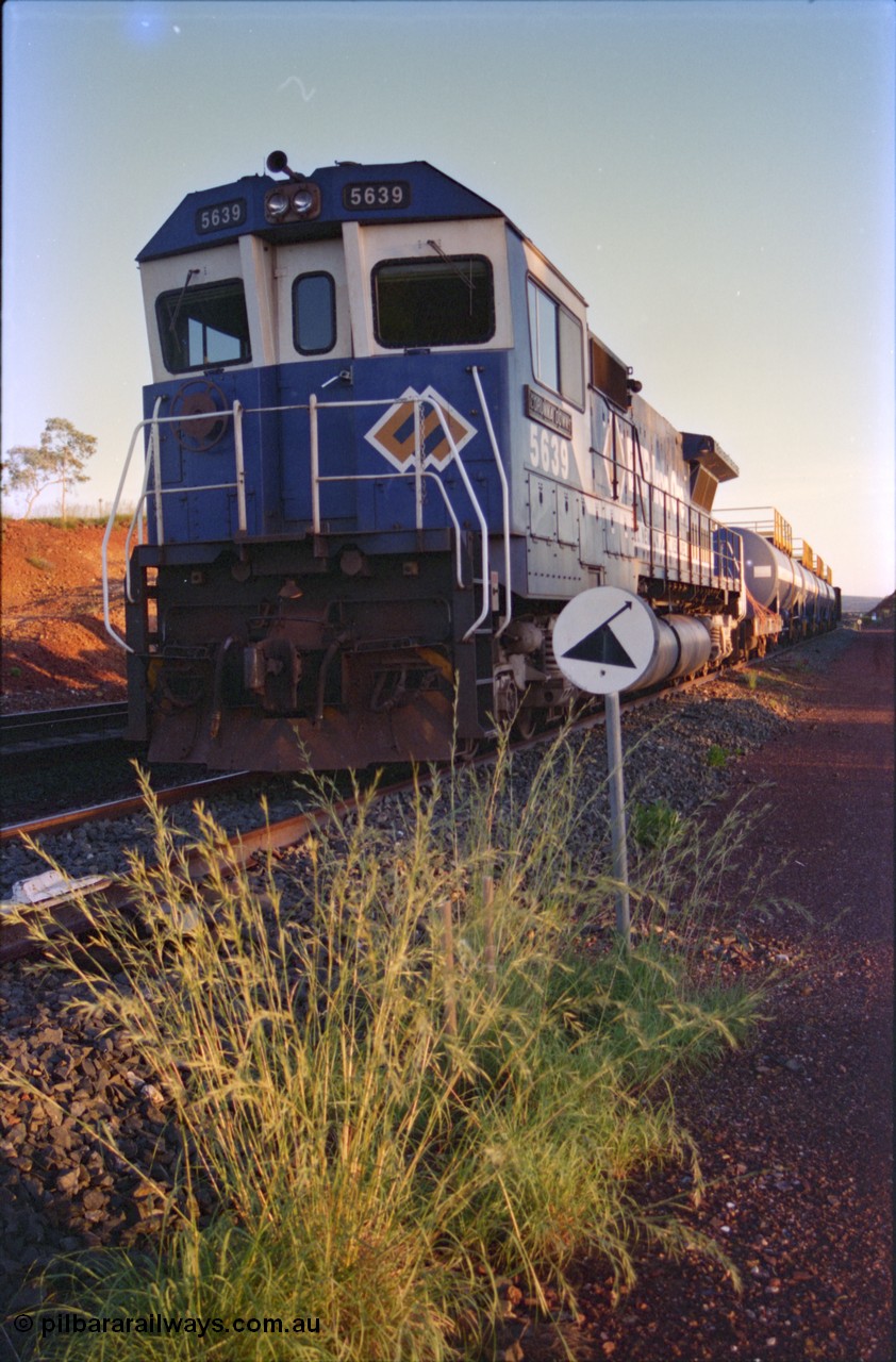 232-12
Yandi One backtrack, following a cyclone shutdown of the mainline and severe flooding around Yandi a 'mixed' freight train was operated to Yandi to deliver food, mail and diesel fuel to the mine and camp. Here BHP Iron Ore unit 5639 'Corunna Downs' serial 8281-03 / 92-128 idles away in the backtrack awaiting its path back to Port Hedland with flat waggon 6703, four fuel tank waggons and a broken ore waggon. [url=https://goo.gl/maps/6c1WFqjYSg42]GeoData[/url].
Keywords: 5639;Goninan;GE;CM40-8M;8281-03/92-128;rebuild;AE-Goodwin;ALCo;C636;5459;G6027-3;