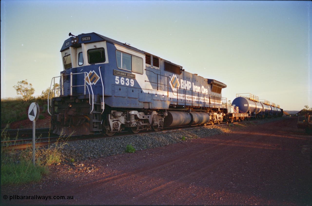 232-16
Yandi One backtrack, following a cyclone shutdown of the mainline and severe flooding around Yandi a 'mixed' freight train was operated to Yandi to deliver food, mail and diesel fuel to the mine and camp. Here BHP Iron Ore unit 5639 'Corunna Downs' serial 8281-03 / 92-128 idles away in the backtrack awaiting its path back to Port Hedland with flat waggon 6703, four fuel tank waggons and a broken ore waggon. [url=https://goo.gl/maps/6c1WFqjYSg42]GeoData[/url].
Keywords: 5639;Goninan;GE;CM40-8M;8281-03/92-128;rebuild;AE-Goodwin;ALCo;C636;5459;G6027-3;