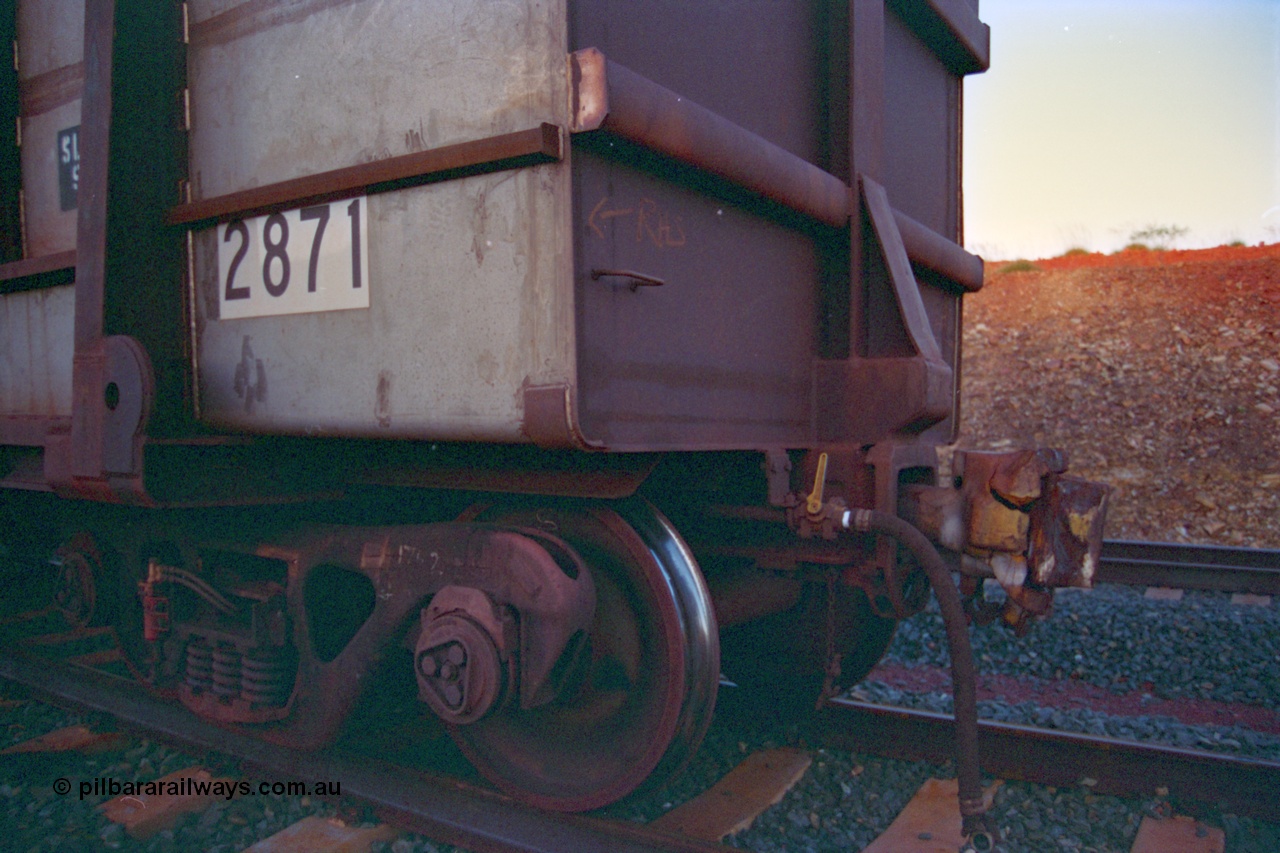 232-20
Yandi One backtrack, following a cyclone shutdown of the mainline and severe flooding around Yandi a 'mixed' freight train was operated to Yandi to deliver food, mail and diesel fuel to the mine and camp. Here BHP Iron Ore loaded Comeng WA built ore waggon 2871 has been re-sheeted with 3CR12 stainless steel side walls, view of broken coupler. February 1997. [url=https://goo.gl/maps/6c1WFqjYSg42]GeoData[/url].
Keywords: 2871;Comeng-WA;