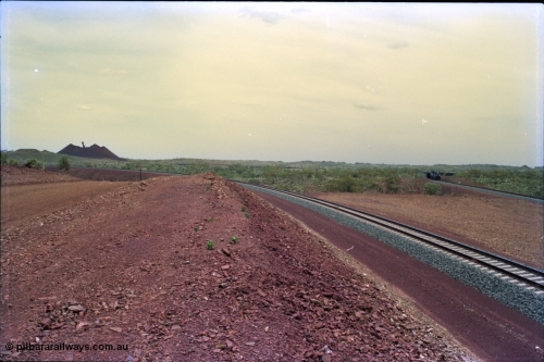 232-03
Yandi Two, view to the stockpile looking west from near the 311.6 km grade crossing. A train can be seen loading on the right. February 1997. [url=https://goo.gl/maps/3tst5WV949N2]GeoData[/url].
