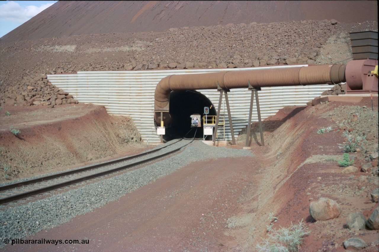 233-04
Yandi Two exit portal or loaded car side of load-out tunnel, the Yandi Two load-out has two load-out stations or vaults to allow to different products to be loaded. Only one vault is used at a time. An empty train can be seen about to enter the tunnel. [url=https://goo.gl/maps/RgJfYGtPXb52]GeoData[/url].
