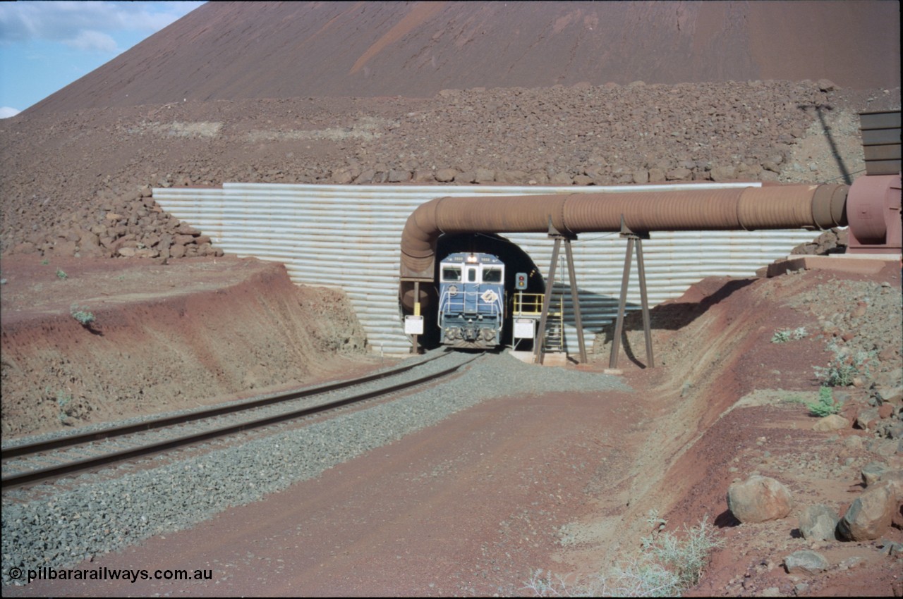 233-08
Yandi Two exit portal or loaded car side of load-out tunnel, the Yandi Two load-out has two load-out stations or vaults to allow to different products to be loaded. Only one vault is used at a time. An empty train lead by BHP Iron Ore's Goninan rebuild CM40-8M GE unit 5650 'Yawata' serial 8412-07 / 93-141 as it drags the train through at 1.2 km/h. [url=https://goo.gl/maps/RgJfYGtPXb52]GeoData[/url].
Keywords: 5650;Goninan;GE;CM40-8M;8412-07/93-141;rebuild;AE-Goodwin;ALCo;M636C;5481;G6061-2;