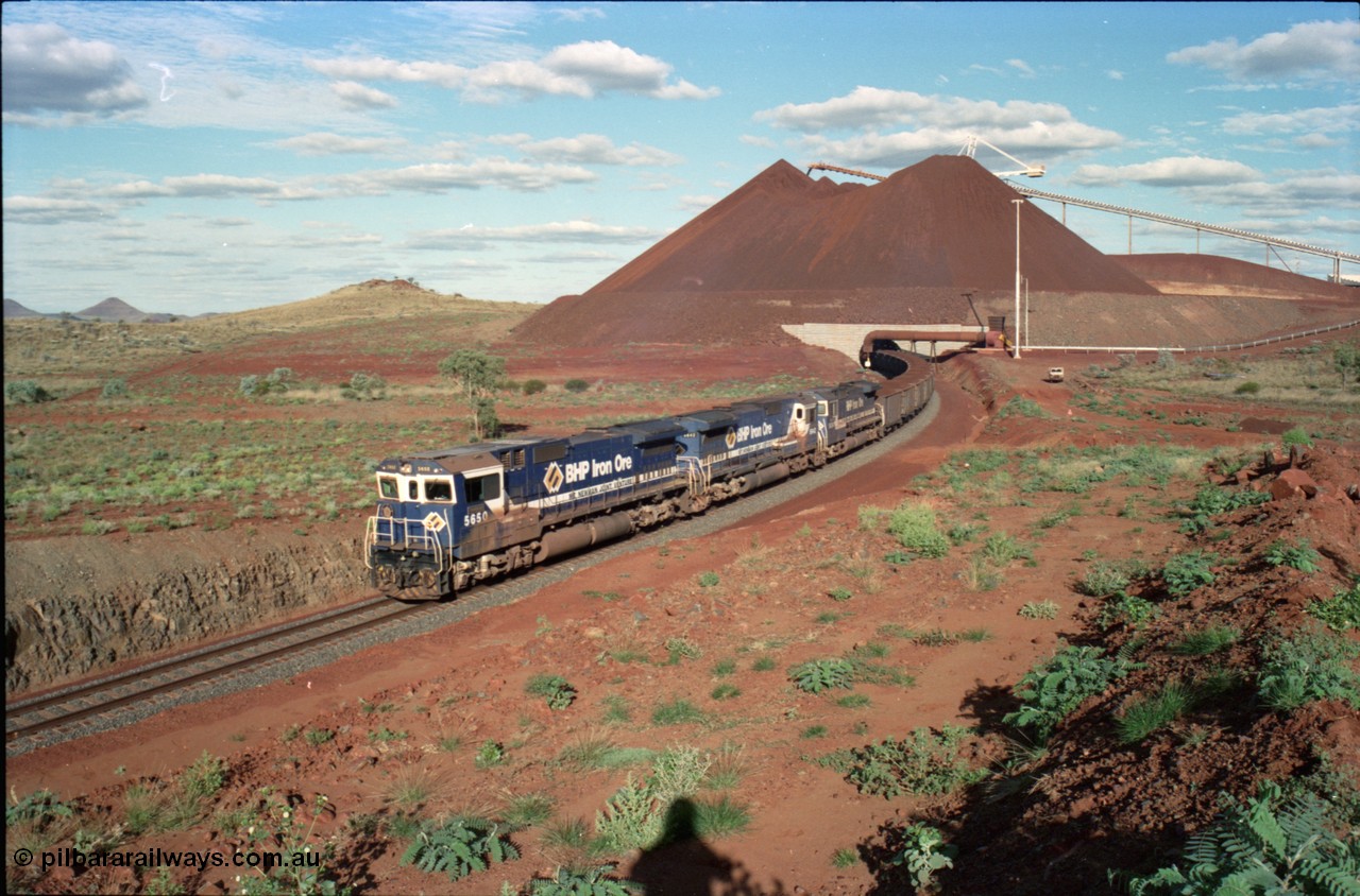 233-29
Yandi Two loaded car side of load-out tunnel, a loading train lead by BHP Iron Ore's Goninan rebuild CM40-8M GE unit 5650 'Yawata' serial 8412-07 / 93-141 as it drags the train through at 1.2 km/h with assistance from two sister units. [url=https://goo.gl/maps/gXRbfYH9U482]GeoData[/url].
Keywords: 5650;Goninan;GE;CM40-8M;8412-07/93-141;rebuild;AE-Goodwin;ALCo;M636C;5481;G6061-2;