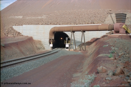 233-06
Yandi Two exit portal or loaded car side of load-out tunnel, the Yandi Two load-out has two load-out stations or vaults to allow to different products to be loaded. Only one vault is used at a time. An empty trains headlight can be seen in the tunnel. [url=https://goo.gl/maps/RgJfYGtPXb52]GeoData[/url].

