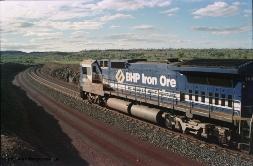 233-31
Yandi Two loaded car side of load-out tunnel, a loading train lead by BHP Iron Ore's Goninan rebuild CM40-8M GE unit 5650 'Yawata' serial 8412-07 / 93-141 as it drags the train through at 1.2 km/h. [url=https://goo.gl/maps/gXRbfYH9U482]GeoData[/url].
Keywords: 5650;Goninan;GE;CM40-8M;8412-07/93-141;rebuild;AE-Goodwin;ALCo;M636C;5481;G6061-2;