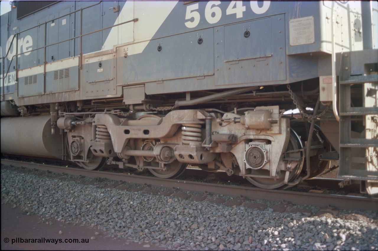 234-15
Yandi Two, BHP Iron Ore Goninan rebuild CM40-8M GE unit 5640 'Ethel Creek' serial 8281-05 / 92-129 is on the rear of a 240 waggon loaded train, this configuration was trialled for a time with two Dash 8 locos, 120 waggons, Dash 8, 120 waggons and Dash 8. View of right hand side leading bogie. Circa 1998.
Keywords: 5640;Goninan;GE;CM40-8M;8281-05/92-129;rebuild;AE-Goodwin;ALCo;M636C;5479;G6047-11;