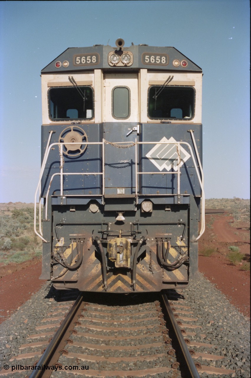 234-20
Yandi Two, BHP Iron Ore Goninan rebuild CM40-8M GE unit 5658 'Kakogawa' serial 8412-03 / 94-149 on the front of a 240 waggon loaded train, this configuration was trialled for a time with two Dash 8 locos, 120 waggons, Dash 8, 120 waggons and Dash 8. Cab front on view. Circa 1998.
Keywords: 5658;Goninan;GE;CM40-8M;8412-03/94-149;rebuild;AE-Goodwin;ALCo;M636C;5480;G6061-1;