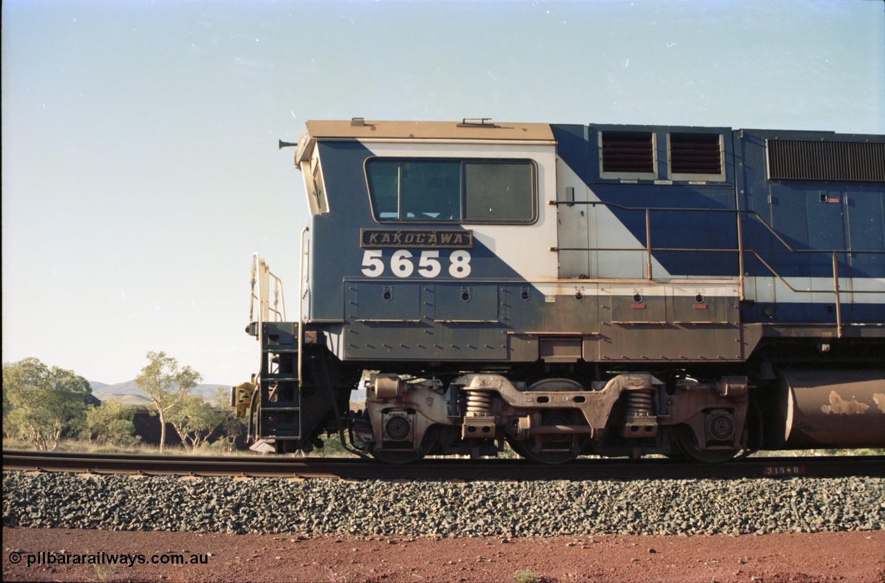 234-30
Yandi Two, BHP Iron Ore Goninan rebuild CM40-8M GE unit 5658 'Kakogawa' serial 8412-03 / 94-149 on the front of a 240 waggon loaded train, this configuration was trialled for a time with two Dash 8 locos, 120 waggons, Dash 8, 120 waggons and Dash 8. Left hand side cab view. Circa 1998.
Keywords: 5658;Goninan;GE;CM40-8M;8412-03/94-149;rebuild;AE-Goodwin;ALCo;M636C;5480;G6061-1;