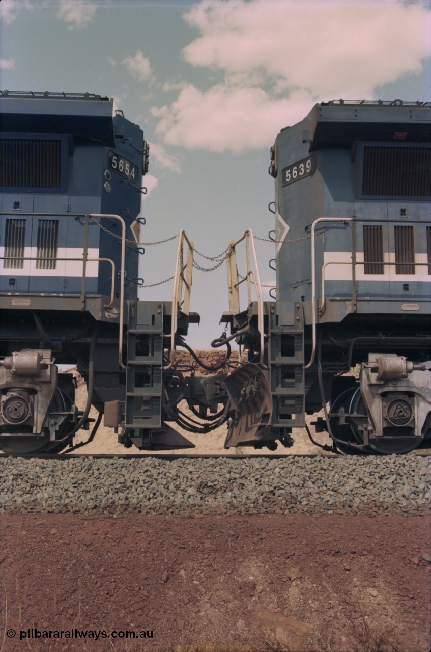235-25
Yandi One, BHP Iron Ore Goninan rebuild CM40-8M GE unit 5654 'Kashima' serial 8412-11 / 93-145 on the left coupled to Goninan GE rebuild 5639 'Corunna Downs' serial 8281-03 / 92-128 on the right, note the differences in the two locos as 5653 is a later rebuild with marker lights and the marigold logo while 5639 has no marker lights, plain logo and a plough fitted to the No.2 end.
