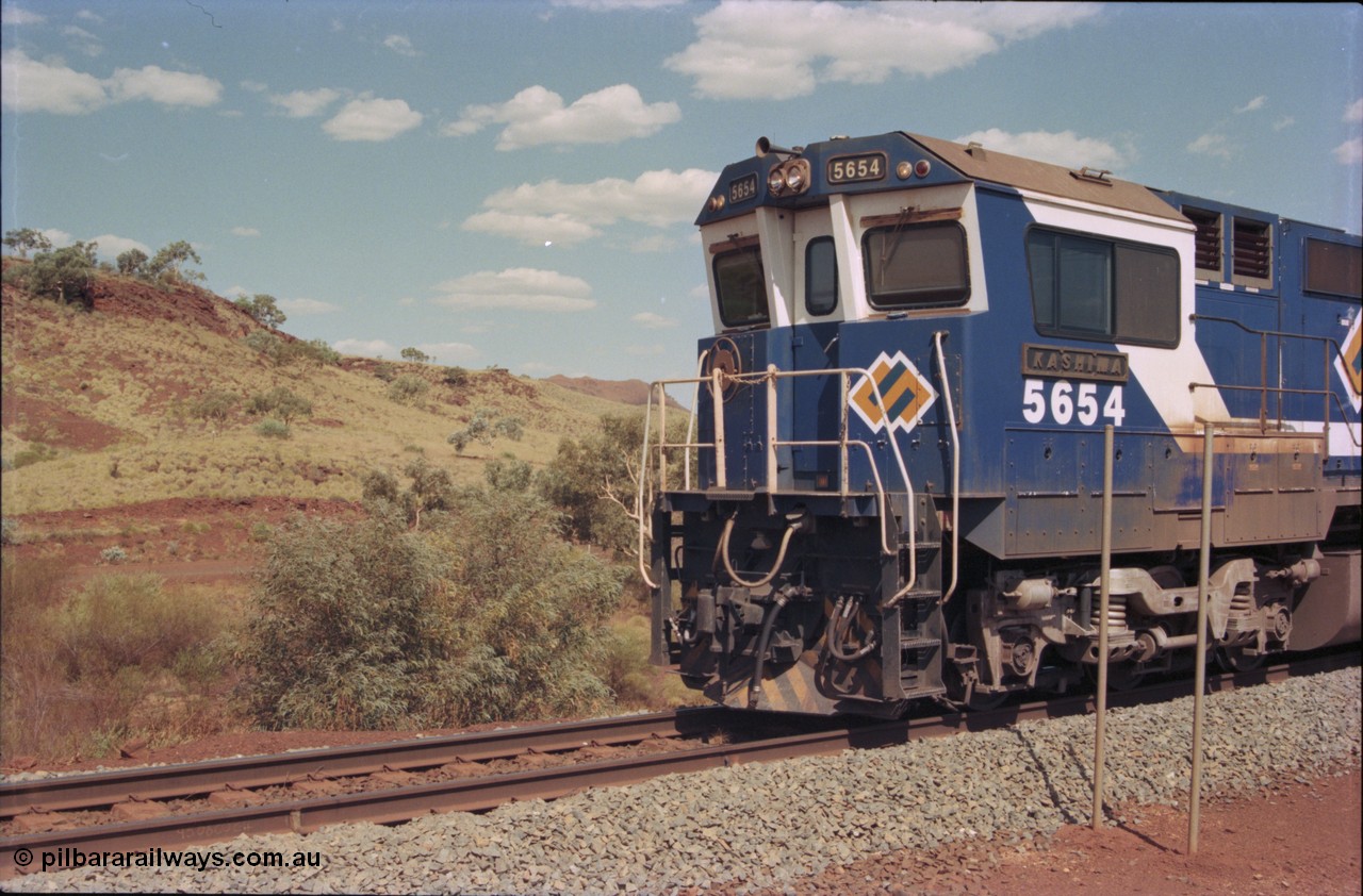235-33
Yandi One, BHP Iron Ore Goninan rebuild CM40-8M GE unit 5654 'Kashima' serial 8412-11 / 93-145 sits on a loaded train awaiting departure time and also has the late marigold style BHP logo, cab side and Alco Hi-Ad bogie.
Keywords: 5654;Goninan;GE;CM40-8M;8412-11/93-145;rebuild;Comeng-NSW;ALCo;M636C;5493;C6084-9;