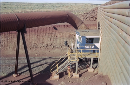235-12
Yandi Two, BHP Iron Ore Goninan rebuild CM40-8M GE unit 5652 'Villanueva' serial 8412-09 / 93-143 passes out the other side of the loadout tunnel as loading has commenced, the dust extraction equipment and retaining wall culvert frame the loco.
Keywords: 5652;Goninan;GE;CM40-8M;8412-09/93-143;rebuild;AE-Goodwin;ALCo;M636C;5482;G6061-3;