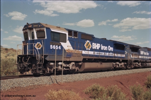 235-19
Yandi One, BHP Iron Ore Goninan rebuild CM40-8M GE unit 5654 'Kashima' serial 8412-11 / 93-145 sits on a loaded train awaiting departure time with second unit also a Goninan GE rebuild 5639 'Corunna Downs' serial 8281-03 / 92-128, note the differences in the two locos as 5653 is rebuilt from a Comeng built ALCo M636 while 5639 was an AE Goodwin built ALCo C636. 5654 also has the late marigold style BHP logo.
Keywords: 5654;Goninan;GE;CM40-8M;8412-11/93-145;rebuild;Comeng-NSW;ALCo;M636C;5493;C6084-9;